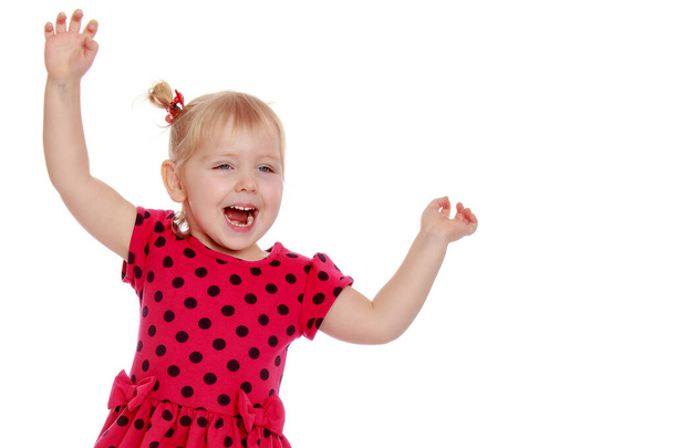 Charming little girl laughing happily in studio - Foto, imagen