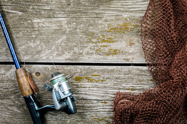 Fishing gear, hooks and baits on a wooden background - Photo, image