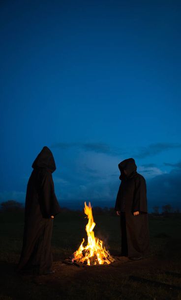 Pagani che adorano intorno a un fuoco
 - Foto, immagini