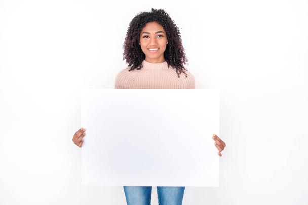 Portrait of black woman holding white banner isolated - Photo, Image