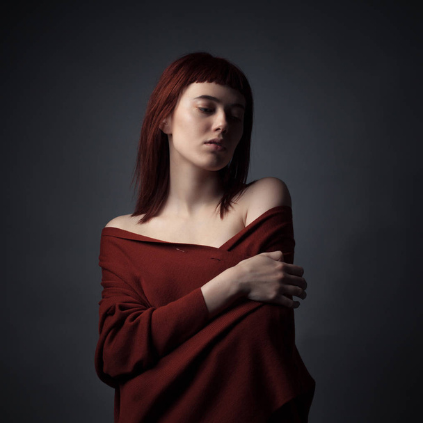 Studio portrait of a beautiful woman with bare shoulders. - Fotó, kép