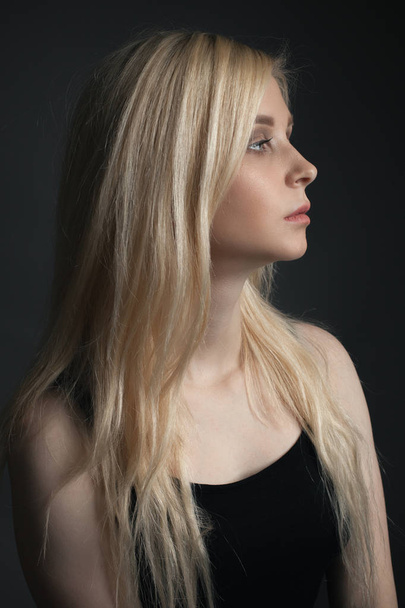 Portrait of young woman with beautiful blonde hair. Profile - Fotografie, Obrázek