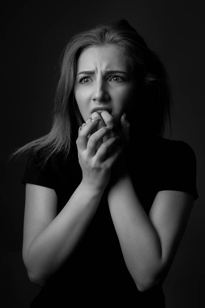 Portrait of scared young woman. Black and white - Photo, image