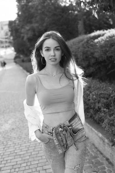 Young beautiful woman walking on the street. Black and white. - Foto, afbeelding
