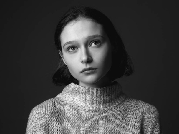 Portrait of pensive young woman. Studio. Black and white. - Photo, Image