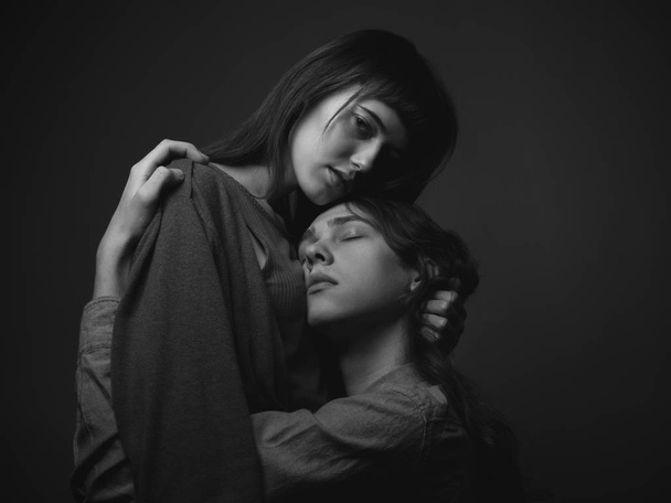 Portrait of young sexy couple on gray background. Black and white. - Foto, afbeelding