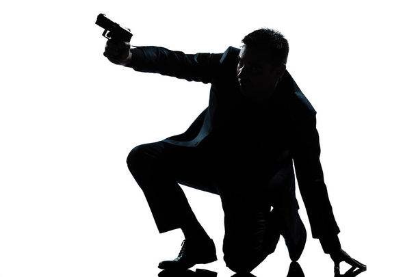 silhouette man kneeling aiming gun - 写真・画像