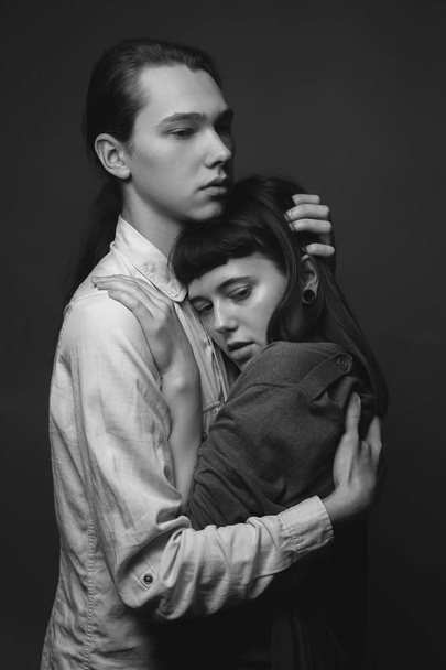 Young couple hugging in studio. Black and white - Φωτογραφία, εικόνα