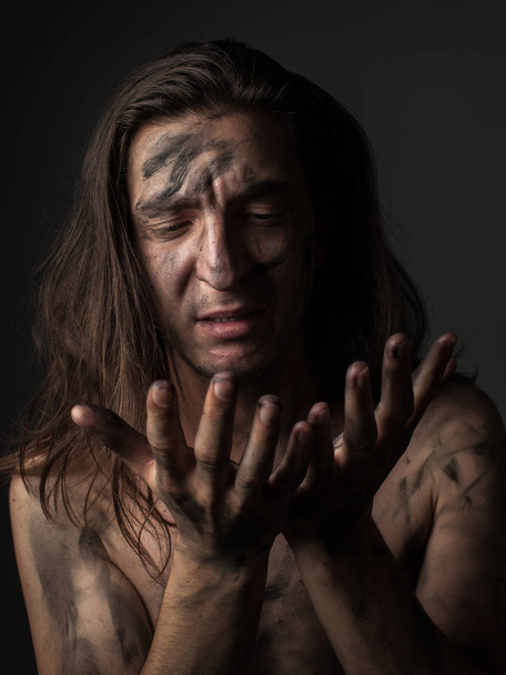 Portrait of unhappy young man with dirty skin - 写真・画像