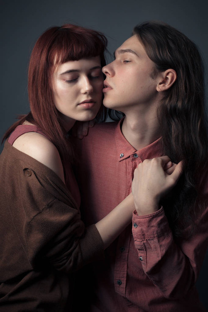 Young passionate couple in love in studio. Cold tonning - Fotó, kép