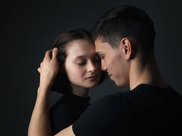 Young couple posing in studio. Low key - Photo, Image