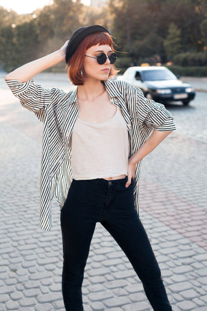 Young fashionable woman in striped shirt posing in the city - Φωτογραφία, εικόνα