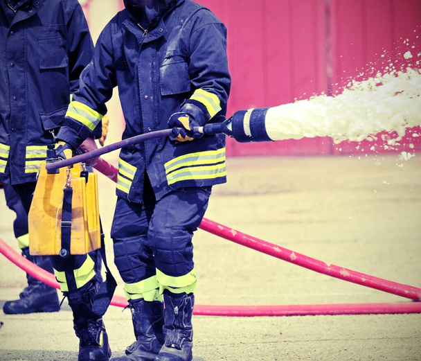 hasič rozstřikuje pěnu z čerpadla - Fotografie, Obrázek