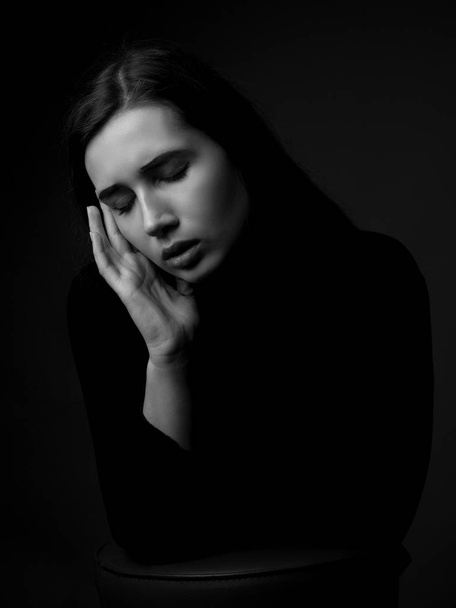 Portrait of sad young woman. Low key. Black and white - Valokuva, kuva