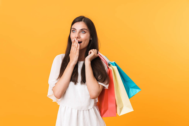 Portrait of excited shopaholic woman wearing dress looking at co - 写真・画像