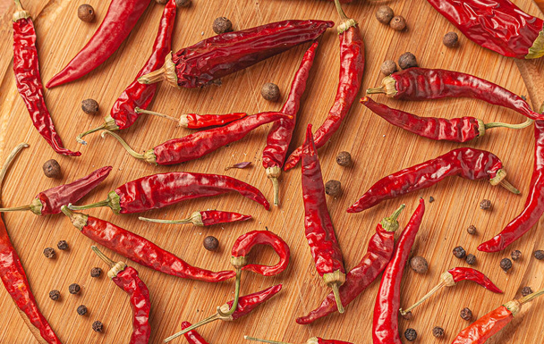 Red chili peppers on a wooden board. - Photo, Image