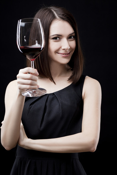 Woman holding wine glass - 写真・画像