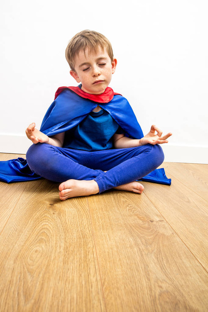 eyes closed superhero child meditating with zen yoga and mindfulness - Фото, изображение