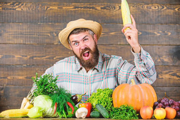 Man with beard wooden background. Become organic farmer. Farmer with organic homegrown vegetables. Grow organic crops. Community gardens and farms. Homegrown organic food. Healthy lifestyle - Φωτογραφία, εικόνα