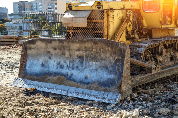 Yellow Bulldozer on new construction site, with the bright sun a - 写真・画像