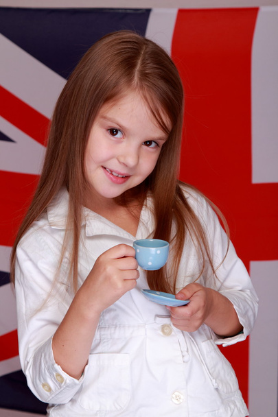 Girl on the background of the flag of Great Britain - Valokuva, kuva