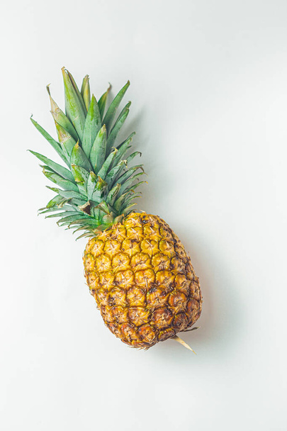 Żółty soczysty świeży ananas na minimalistycznym tle - Zdjęcie, obraz