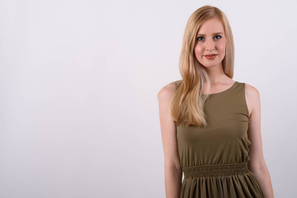 Young beautiful British woman with blond hair against white background - Foto, afbeelding