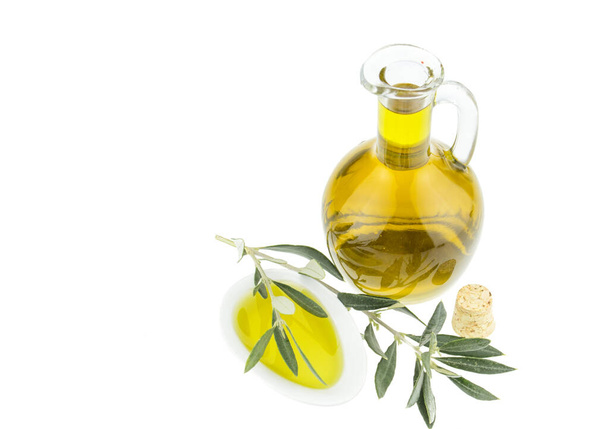 Olivenölflasche und Teller mit Olivenzweig. natives Olivenöl. natürliches Olivenöl, gesunde Ernährung. natürliche mediterrane Kost. Brotdippen. - Foto, Bild