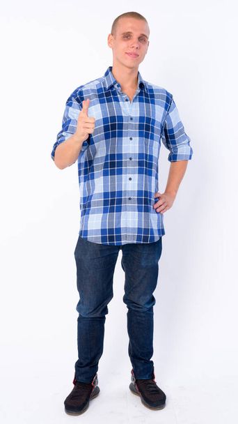 Full body shot of happy young bald hipster man pointing at camera - Foto, imagen