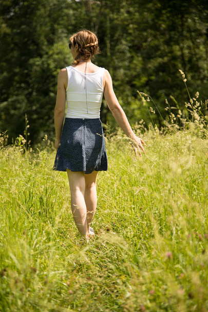 girl in green field at summer time - Photo, Image