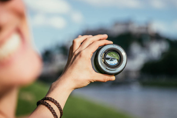 Photographer holds a professional photo optic in his hand - Zdjęcie, obraz