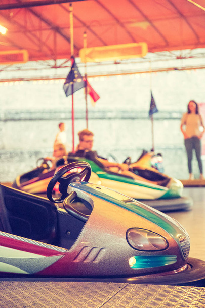 Bumper cars with people in Amusement park - Foto, afbeelding