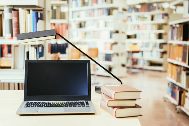 laptop with books on wooden table - Fotó, kép