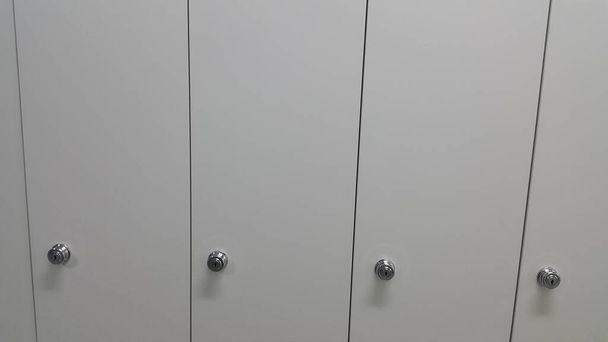 Perspective view of lockers or cupboards in a row with white doors - Photo, Image