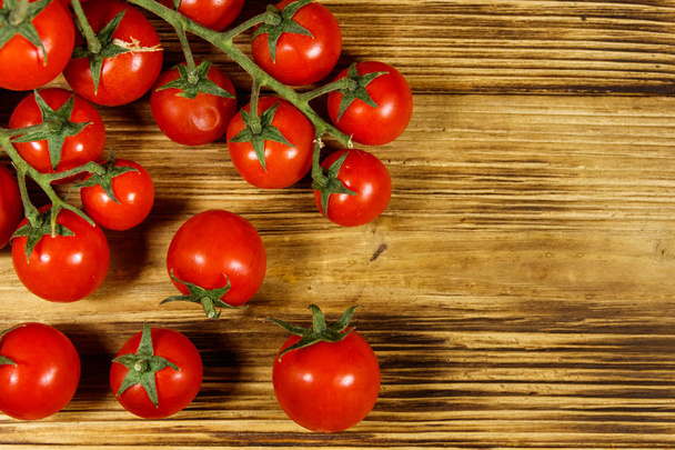 Fresh cherry tomatoes on a wooden table. Top view - Photo, Image