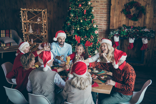 Portrait of nice lovely cheerful big full family couples brother sister wearing cap hat headwear enjoying celebrating December wintertime tradition in loft industrial style interior house indoors - Photo, image