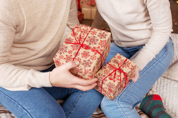Hands of man and woman holding a Christmas gift boxes.  Christma - 写真・画像