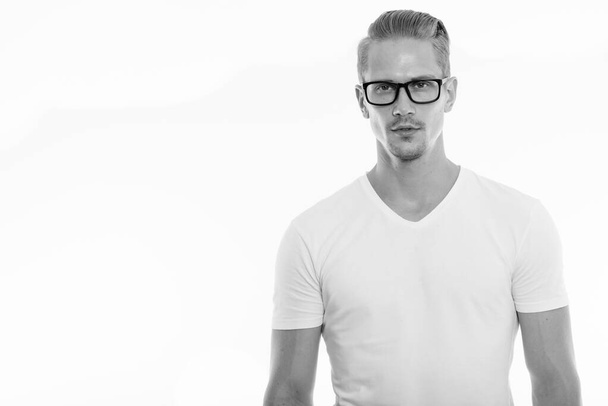 Studio shot of young handsome man wearing eyeglasses - Photo, Image