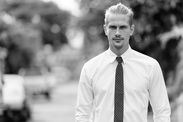 Young handsome businessman outdoors in black and white - Photo, Image