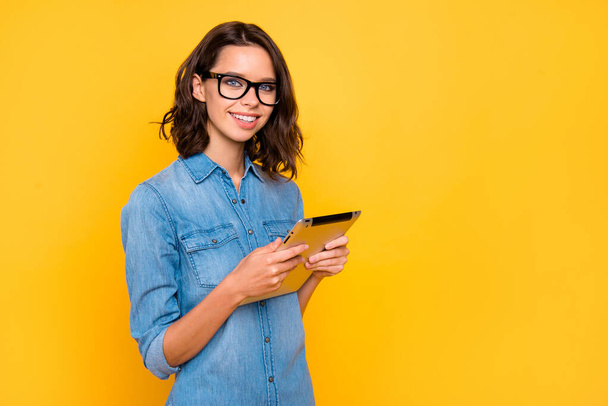 Portrait of cool confident positive freelancer use her tablet work on university project feel content wear stylish clothes isolated over yellow color background - Фото, изображение
