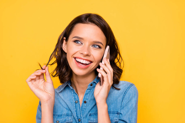 Close up photo of cheerful positive funny funky girl hold her smart phone call chill have conversation with best friends wear trend outfit isolated over yellow color background - Foto, afbeelding