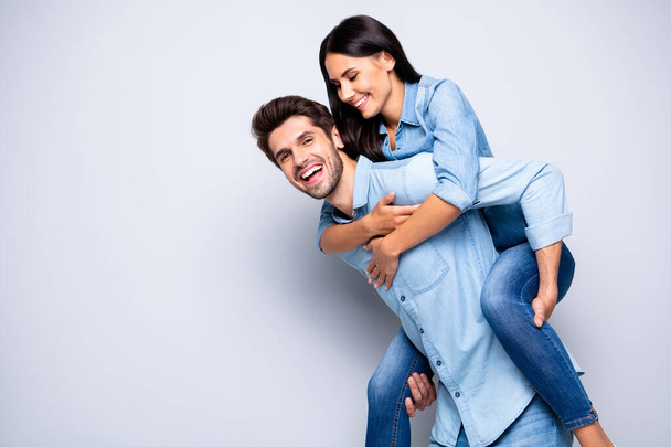 Profile photo of funny guy and lady holding piggyback playing leisure game rejoicing wear casual jeans clothes isolated grey color background - Fotó, kép