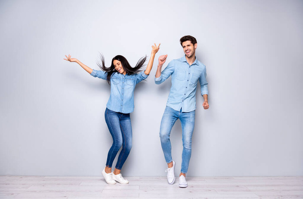 Full length photo of funny guy and lady chilling at disco party dancing throwing hair air wear casual jeans clothes isolated grey color background - Фото, изображение