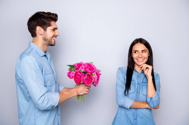 Portrait of nice attractive charming cute sweet dreamy lovely cheerful cheery couple guy handling holding in hands natural roses isolated on light white gray pastel color background - 写真・画像