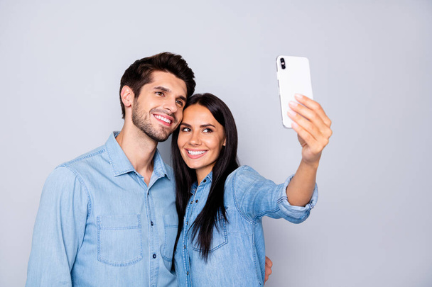 Photo of cheerful trendy charming cute nice couple of two people taking selfie smiling toothily hugging isolated grey color background - Zdjęcie, obraz