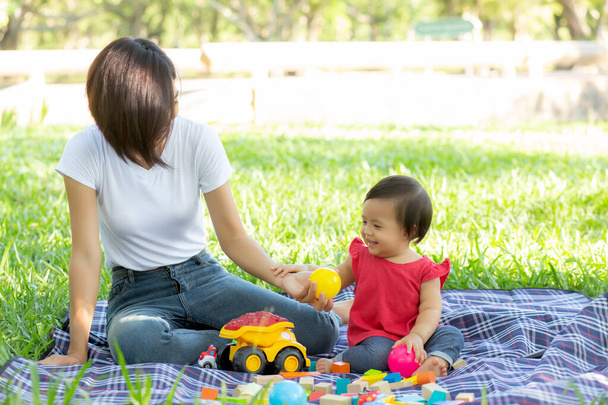 Beautiful young asian mom and daughter playing toy blocks for le - Photo, Image