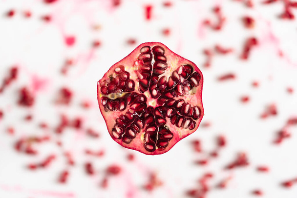 Fresh pomegranate with red seeds on a light background - Foto, imagen