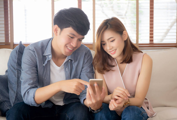 Young asian couple or friend looking smart mobile phone with enj - Photo, Image