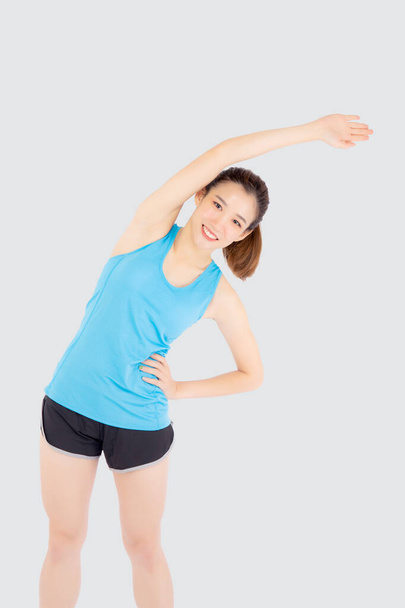 Beautiful young asian woman in sport standing stretch muscle arm - Photo, Image