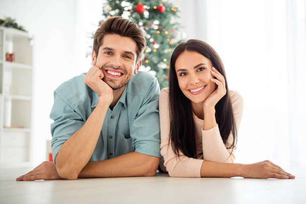 Close up photo of two people couple lying on floor enjoy christmas time x-mas holidays in house indoors - Foto, imagen